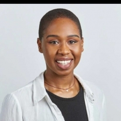 A portrait of Kristina Modeste smiling with a white background