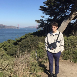 Nick Hallin standing in front of the SF Bay with the Golden Gate Bridge in the background